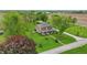 Picturesque aerial view of brick home with barn nestled amidst green fields and mature trees at 1901 S Old State Road 67, Paragon, IN 46166