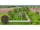 Charming aerial view of the brick home, featuring mature trees and beautifully maintained lawns at 1901 S Old State Road 67, Paragon, IN 46166