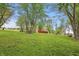 Large green backyard with mature trees, a silo, barn, and a swing at 1901 S Old State Road 67, Paragon, IN 46166