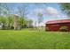 Large green backyard with a silo and red barn featuring signage at 1901 S Old State Road 67, Paragon, IN 46166