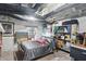 Basement bedroom featuring brick walls, shelves, exposed ductwork, and a cozy bedroom setting at 1901 S Old State Road 67, Paragon, IN 46166