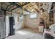 Unfinished basement with water heater, exposed pipes, and cement floor at 1901 S Old State Road 67, Paragon, IN 46166