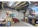 Basement room featuring a bed, exposed duct work, a desk, shelves and brick walls at 1901 S Old State Road 67, Paragon, IN 46166