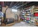 Basement utility area featuring exposed ductwork, a small window, and organized shelving with various household items at 1901 S Old State Road 67, Paragon, IN 46166