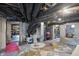Open basement utility area featuring exposed ductwork and walls, with a hot water heater and visible storage areas at 1901 S Old State Road 67, Paragon, IN 46166