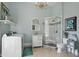 Bright bathroom with a tiled walk-in shower, modern fixtures, and a convenient laundry area, all under a chandelier at 1901 S Old State Road 67, Paragon, IN 46166