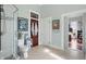 Well-lit bathroom featuring a tiled shower, toilet, and a view into another room through an open doorway at 1901 S Old State Road 67, Paragon, IN 46166