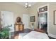 Bright bedroom features hardwood floors, vintage furniture, and a doorway view to the staircase at 1901 S Old State Road 67, Paragon, IN 46166