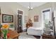 A bright bedroom with classic decor, including hardwood floors, colorful artwork, and a vintage-style furnishing at 1901 S Old State Road 67, Paragon, IN 46166