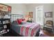 Comfortable bedroom with queen bed, decorative pillows, and a large window at 1901 S Old State Road 67, Paragon, IN 46166