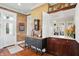 Entryway displaying exposed brick, hardwood floors, and antique furnishings, leading into a bright and inviting home at 1901 S Old State Road 67, Paragon, IN 46166