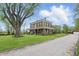 Stately two-story brick home featuring a wraparound porch and large front yard with mature tree at 1901 S Old State Road 67, Paragon, IN 46166