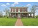 Beautiful brick home with a wide, inviting front porch and meticulous landscaping along a brick walkway at 1901 S Old State Road 67, Paragon, IN 46166