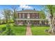 Charming two-story brick home featuring a spacious porch, manicured lawn, and beautiful landscaping at 1901 S Old State Road 67, Paragon, IN 46166