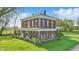 View of brick home with white trim and long front porch, surrounded by green grass and blue skies at 1901 S Old State Road 67, Paragon, IN 46166