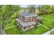 Aerial view of a brick two-story home featuring a wraparound porch and lush landscaping at 1901 S Old State Road 67, Paragon, IN 46166