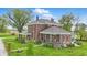 Landscaped yard with mature trees surrounding a beautiful home with a covered porch at 1901 S Old State Road 67, Paragon, IN 46166