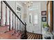 Elegant foyer with wood staircase, chandelier, and decorative front door with glass inserts at 1901 S Old State Road 67, Paragon, IN 46166