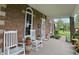 Relaxing front porch featuring rocking chairs, brick columns, and views of the yard at 1901 S Old State Road 67, Paragon, IN 46166