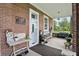 Charming covered front porch with brick accents and decorative furniture at 1901 S Old State Road 67, Paragon, IN 46166