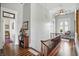 Well-lit hallway with hardwood floors, elegant banister, and decorative furnishings at 1901 S Old State Road 67, Paragon, IN 46166