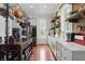 Bright kitchen featuring an island, hardwood floors, stainless steel appliances, and exposed brick accents at 1901 S Old State Road 67, Paragon, IN 46166
