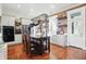 Spacious kitchen featuring hardwood floors, exposed brick, stainless steel appliances, and a pot rack at 1901 S Old State Road 67, Paragon, IN 46166