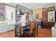 Open kitchen featuring an island with a pot rack, exposed brick wall, and farmhouse sink at 1901 S Old State Road 67, Paragon, IN 46166