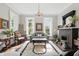 Bright living room featuring hardwood floors, arched windows, chandelier, and fireplace at 1901 S Old State Road 67, Paragon, IN 46166