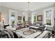 Bright, neutral living room with decorative rug, chandelier, and arched windows with natural light at 1901 S Old State Road 67, Paragon, IN 46166