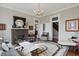 Bright living room featuring a brick fireplace, hardwood floors, and an ornate chandelier at 1901 S Old State Road 67, Paragon, IN 46166