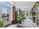 Cozy sunroom with brick accent wall, many windows and plants at 1901 S Old State Road 67, Paragon, IN 46166