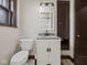 Classic bathroom featuring a granite-topped vanity and a convenient toilet at 270 W Broadway St, Shelbyville, IN 46176