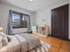 Bedroom with hardwood floors, white furniture, and natural light at 270 W Broadway St, Shelbyville, IN 46176