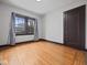 Bright bedroom with wood floors, natural light from window, and neutral wall paint at 270 W Broadway St, Shelbyville, IN 46176