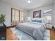 Staged bedroom with modern furniture and a decorative rug on hardwood floors at 270 W Broadway St, Shelbyville, IN 46176