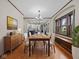 Open dining room with hardwood floors and modern decor seamlessly connects to the adjacent kitchen for easy entertaining at 270 W Broadway St, Shelbyville, IN 46176