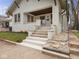 Stylish white brick front entrance with stone details and updated concrete steps at 270 W Broadway St, Shelbyville, IN 46176
