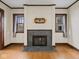 Elegant fireplace with slate surround, flanked by windows with natural light, complements the home's architectural details at 270 W Broadway St, Shelbyville, IN 46176