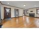 Spacious living room with hardwood floors and fireplace with lots of natural light and neutral paint at 270 W Broadway St, Shelbyville, IN 46176