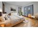 Cozy primary bedroom with natural light, neutral decor and hardwood flooring at 270 W Broadway St, Shelbyville, IN 46176