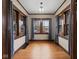 Bright sun room with beautiful dark trim, hardwood floors, and ample natural light at 270 W Broadway St, Shelbyville, IN 46176