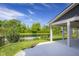 Inviting covered patio offering serene backyard views with a pond and surrounding greenery at 2736 Victory Dr, Columbus, IN 47203