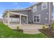 Spacious backyard with covered patio, lush lawn, and black fencing, ideal for outdoor activities and gatherings at 2736 Victory Dr, Columbus, IN 47203