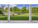 View of the lush backyard with a black metal fence and tranquil water feature beyond at 2736 Victory Dr, Columbus, IN 47203