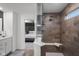 A modern bathroom features a glass enclosed shower with a built-in bench and wood-look tile at 2736 Victory Dr, Columbus, IN 47203
