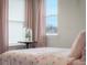 Bright bedroom featuring a floral bedspread, side table, and natural light at 2736 Victory Dr, Columbus, IN 47203