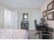 Comfortable bedroom with a modern workspace, featuring a black desk and framed diplomas at 2736 Victory Dr, Columbus, IN 47203