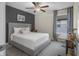 Neutral bedroom featuring a ceiling fan, decorative accent wall, carpet, and writing desk at 2736 Victory Dr, Columbus, IN 47203