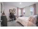 Bright bedroom featuring a home office, plush bedding, and natural light at 2736 Victory Dr, Columbus, IN 47203